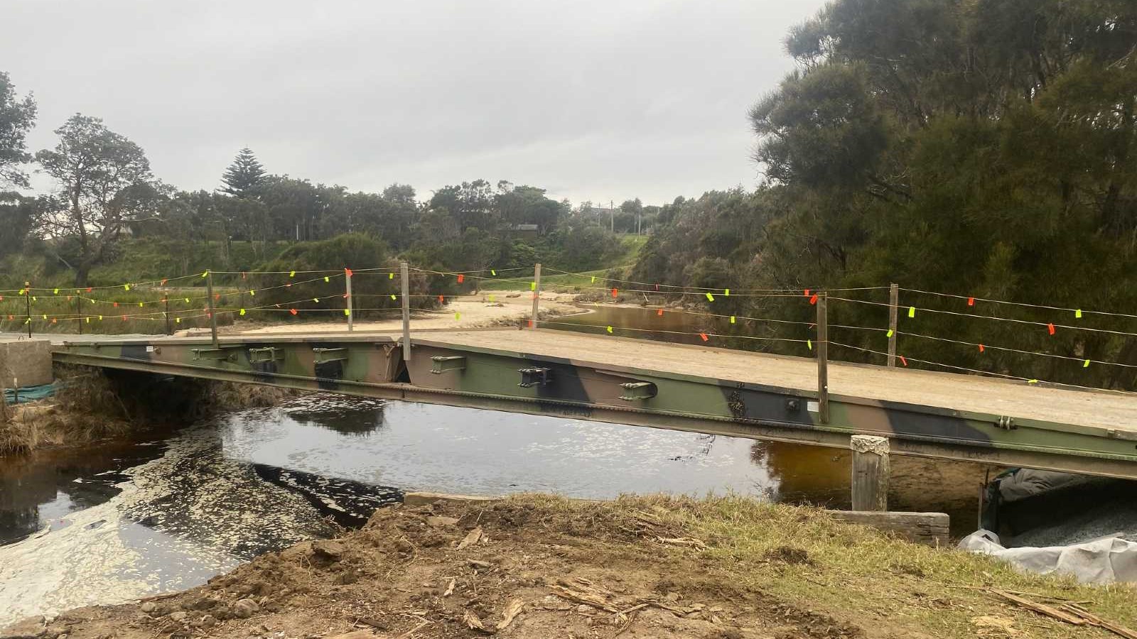 A temporary bridge spans across a creek