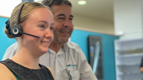 Female with headset on next to a man