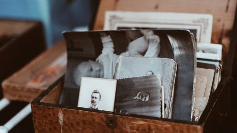 Wooden box of old black and white photos.