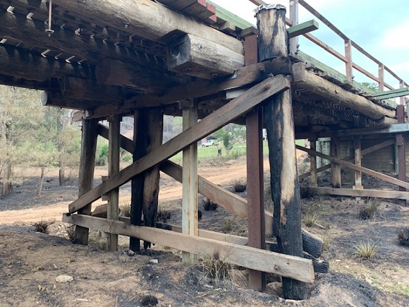 Image The upright structural timbers of the bridge are burnt