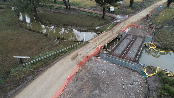 Image A drone photo shows a new bridge under construction alongside the sold timber bridge