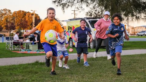 Young people playing with a soccer ball.