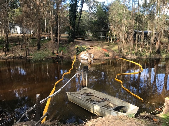 Image The bridge has been demolished leaving behind a couple of posts in the creek