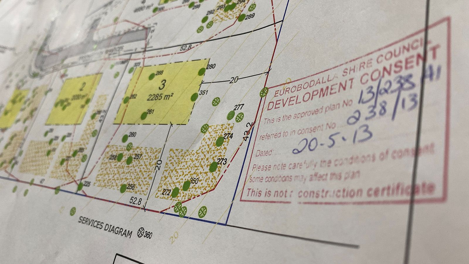 A copy of house plans with a consent notice stamped onto the paper banner image