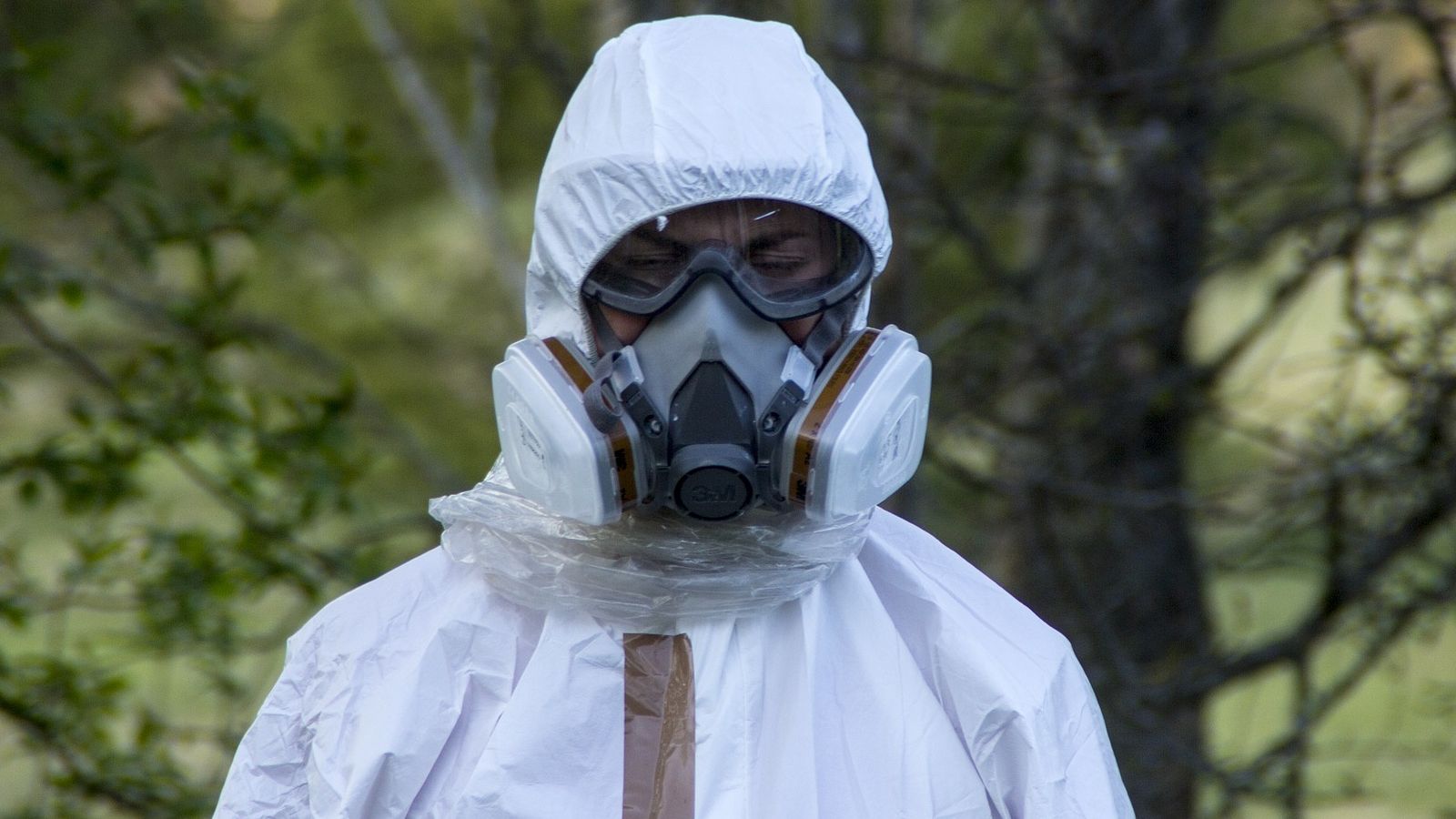 The words 'Caution asbestos' spray painted on industrial materials banner image