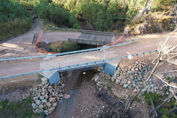 Image An aerial image shows a new bridge built next to an old timber bridge.