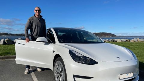 Mayor standing next to a Tesla