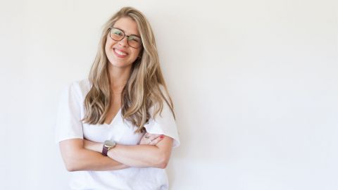 Female with arms crossed smiling